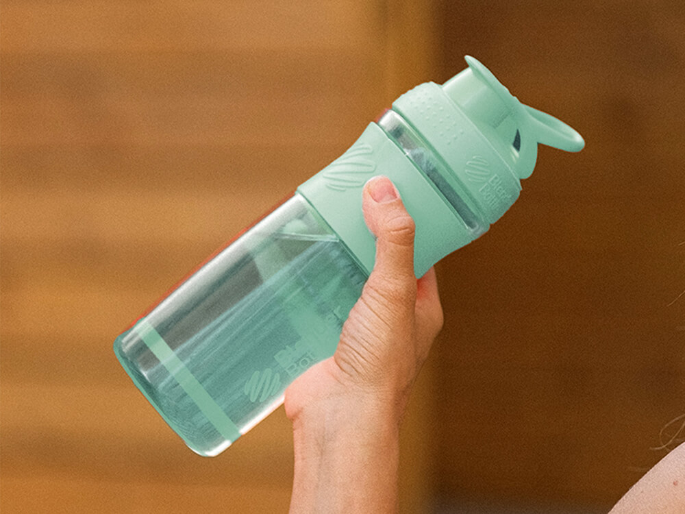 Hand holding up a reusable water bottle