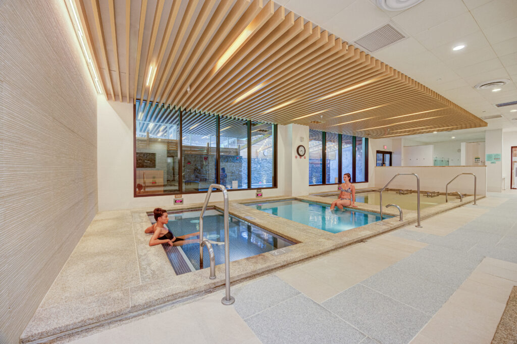 Two women relax in the baths in the bath house