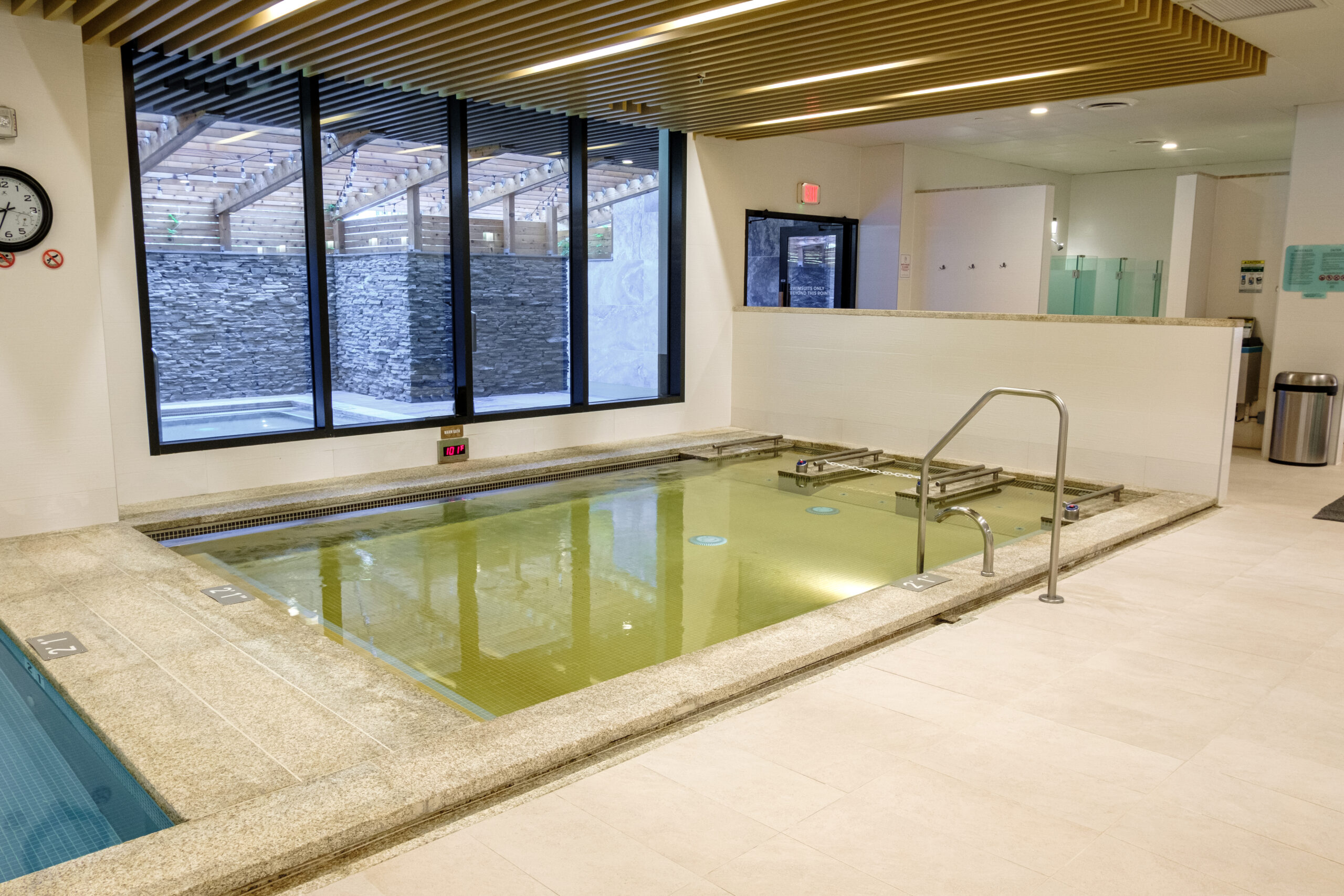 In ground warm bath located in a bath house.